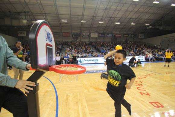 Anthony Carreno, 8,  shows some style at a Santa Cruz Warriors Kids Slam Dunk Contest last night. Chip Scheuer photo.