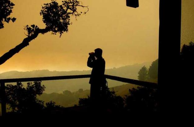 Dec. 16: C Kevin Smith scans the fires through a very smoky sky. Where the fire is next going is still very iffy. There have been multiple, very long chains of fire marching through Lower Pfeiffer. Trees exploding, propane tanks torching all night. Woof. Dec. 16: C Kevin Smith scans the fires through a very smoky sky. Where the fire is next going is still very iffy. There have been multiple, very long chains of fire marching through Lower Pfeiffer. Trees exploding, propane tanks torching all night. Woof.