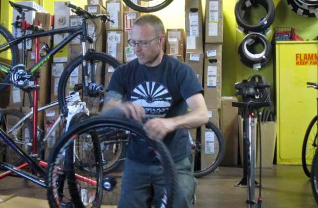 Nate Trumble spins the wheel of misfortune in the 'fix a flat' part of the pre-ride workshop at Bicycle Trip. HT photo.