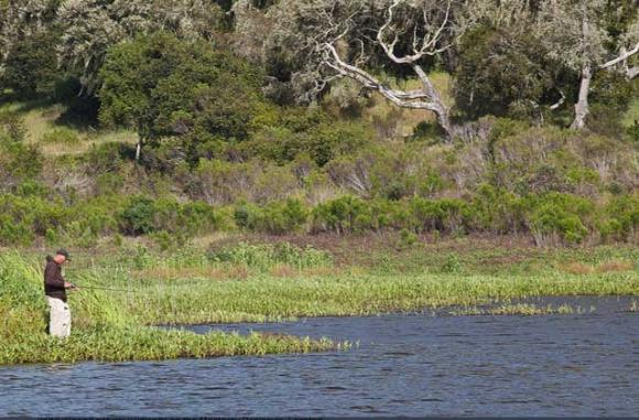 An angler on Mudhen Lake in the Fort Ord National Monument.
