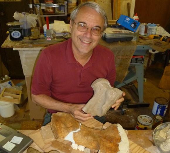 Frank Perry holding a cast of a fossil sea cow bone from Scotts Valley. Photo by Jill Perry.