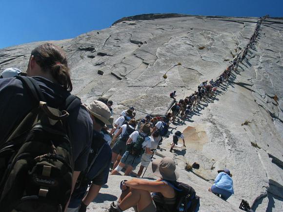 Hikers on the Half Dome cables at Yosemite. Photo by Daniel Schwen on Creative Commons. 