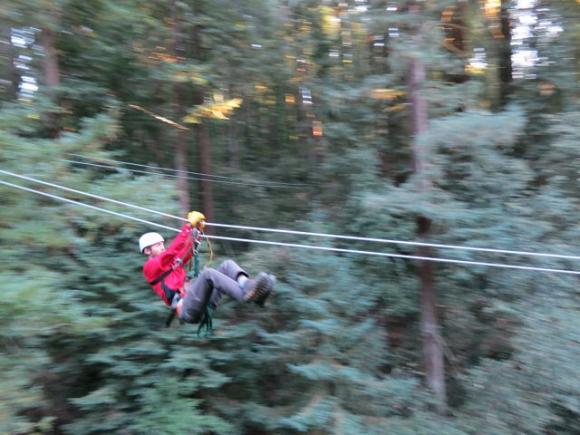 The ideal posture for zipping across the chasm: safe handgrip, knees bent and ready to have a blast. Karen Kefauver photo.
