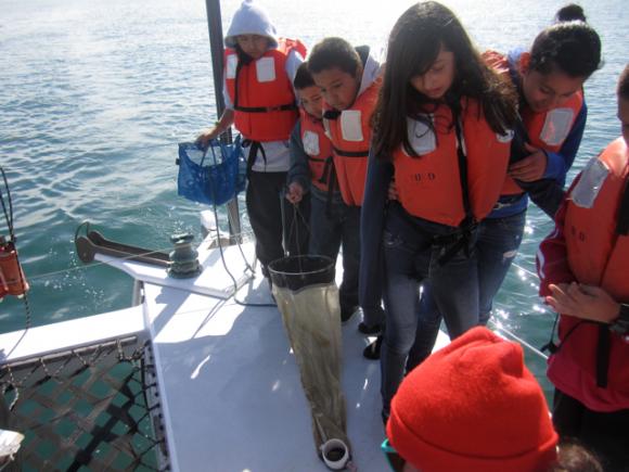 Fifth graders from Watsonville's Ann Soldo Elementary School help O'Neill Sea Odyssey instructor Celia Lara collect a seawater sample for examination. All photos by Hilltromper.