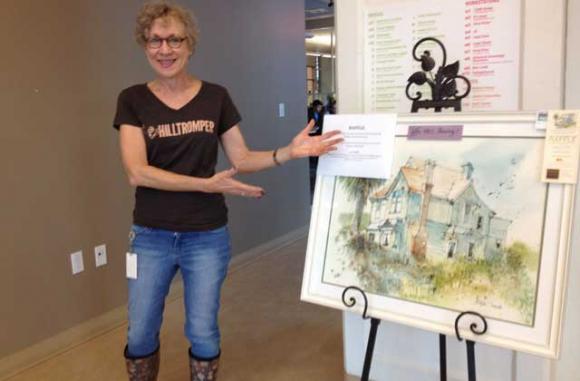 You can win the lovely painting that Renee Winter, local attorney and happy Hilltromper, is pointing to!