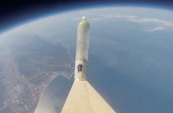 Yes, that's a young redwood tree in a plastic bottle. In space. (A screenshot from the first GoPro video of a sequoia sempervirens in the Mesosphere.)