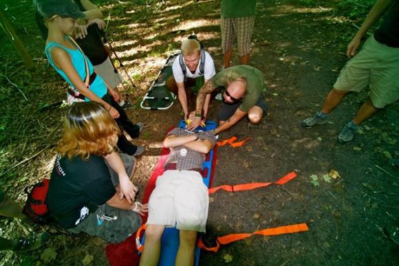 Wilderness first aid instructor Mike Stahlman demonstrates how to stabilize a patient's upper body. Photo courtesy Mike Stahlman. 